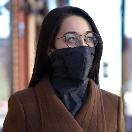 Face warmer (The Commuter by Emberhurst) with a design that prevents glasses from fogging, worn by a woman with glasses. 